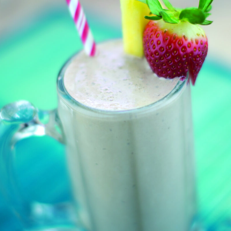 A creamy chocolate hazelnut shake served in a glass, topped with whipped cream and a sprinkle of chopped hazelnuts.