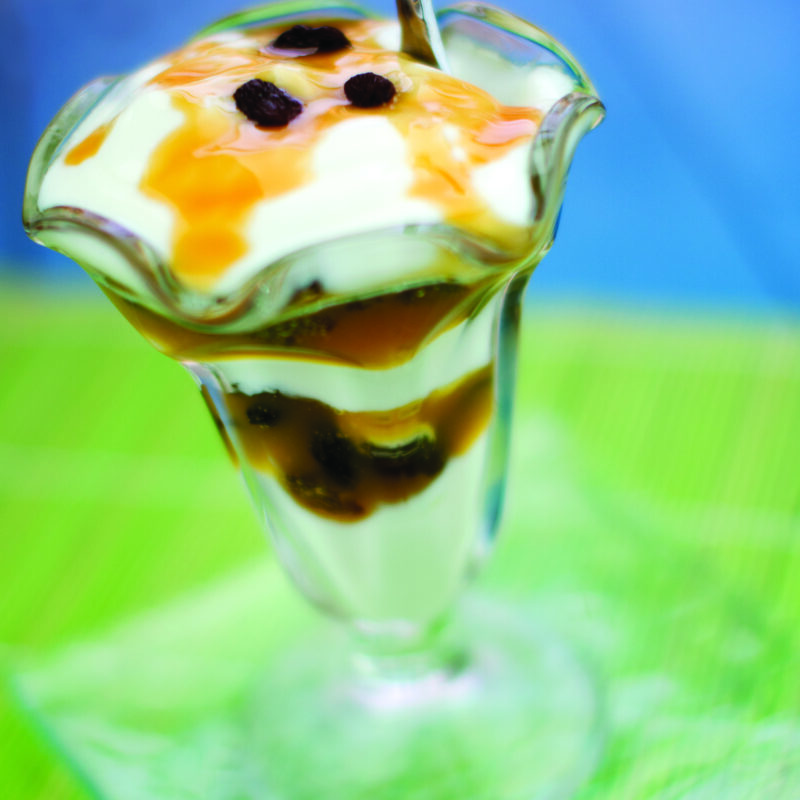 A gooey butterscotch and raisin parfait layered with creamy yogurt and topped with raisins and butterscotch drizzle.