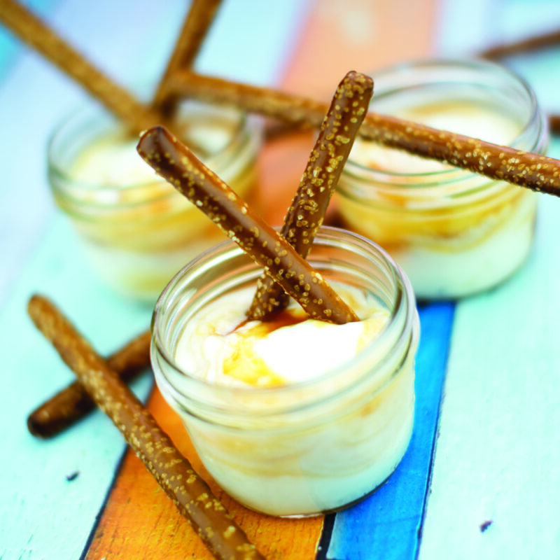 Salted pretzel and caramel yogurt dippers, with pretzels dipped in creamy yogurt and drizzled with caramel sauce.