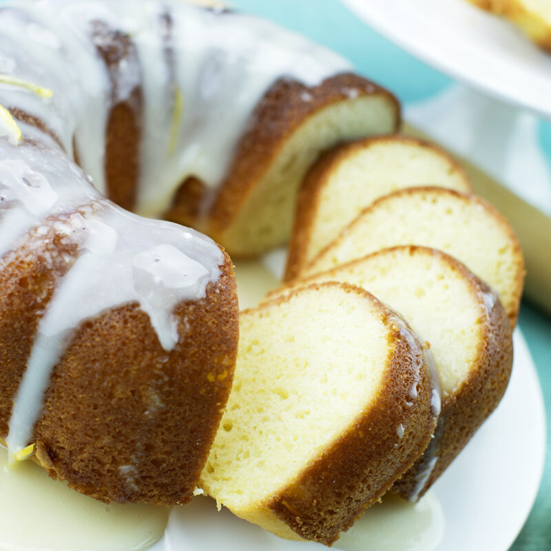 Lemon and yogurt pound cake slices on a plate with a light glaze.
