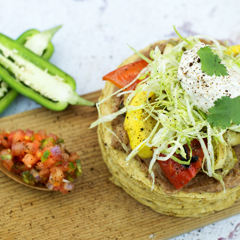 South of the Border veggie tostadas topped with fresh vegetables and a tangy sauce.